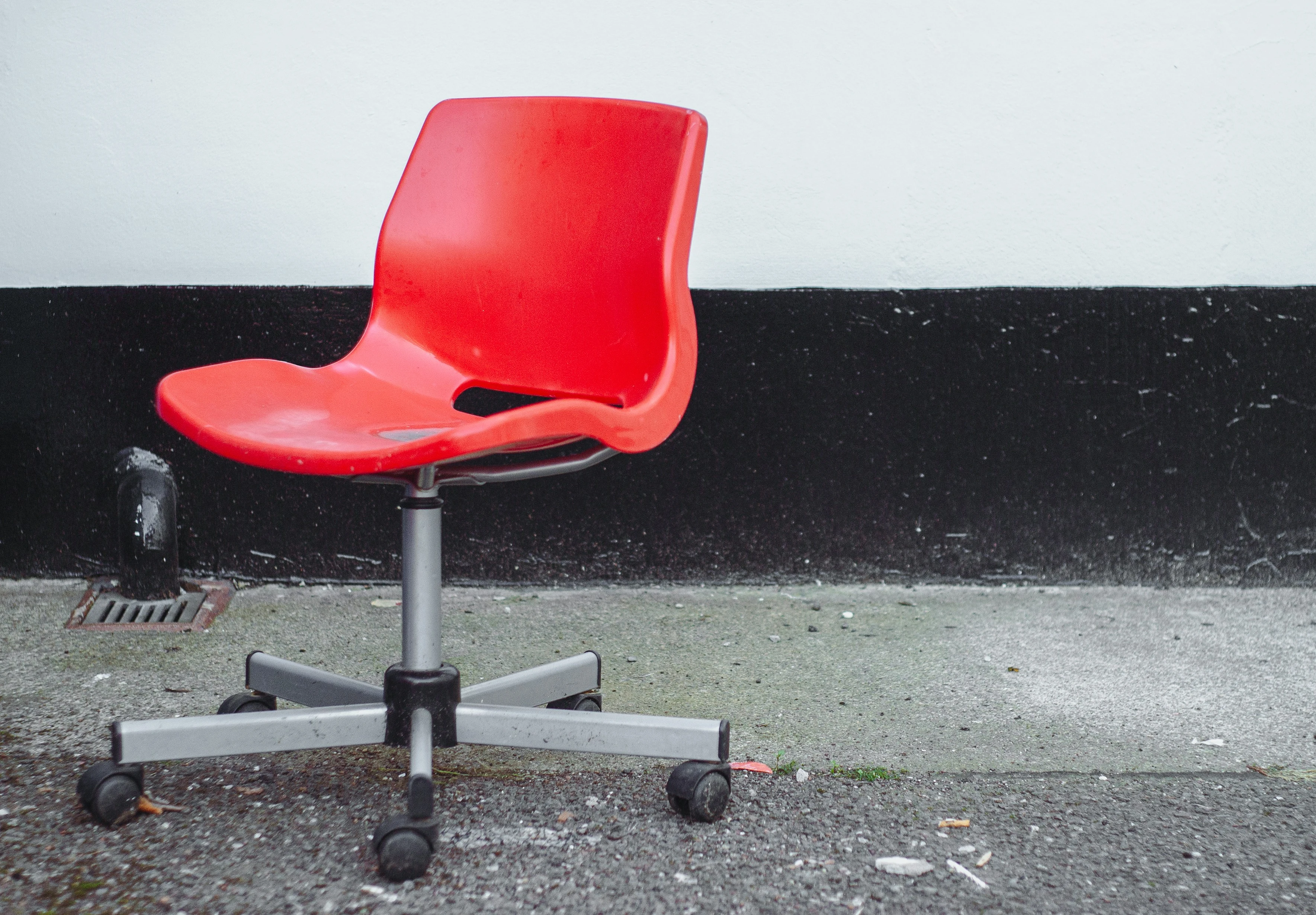 Red plastic chair with metal leg