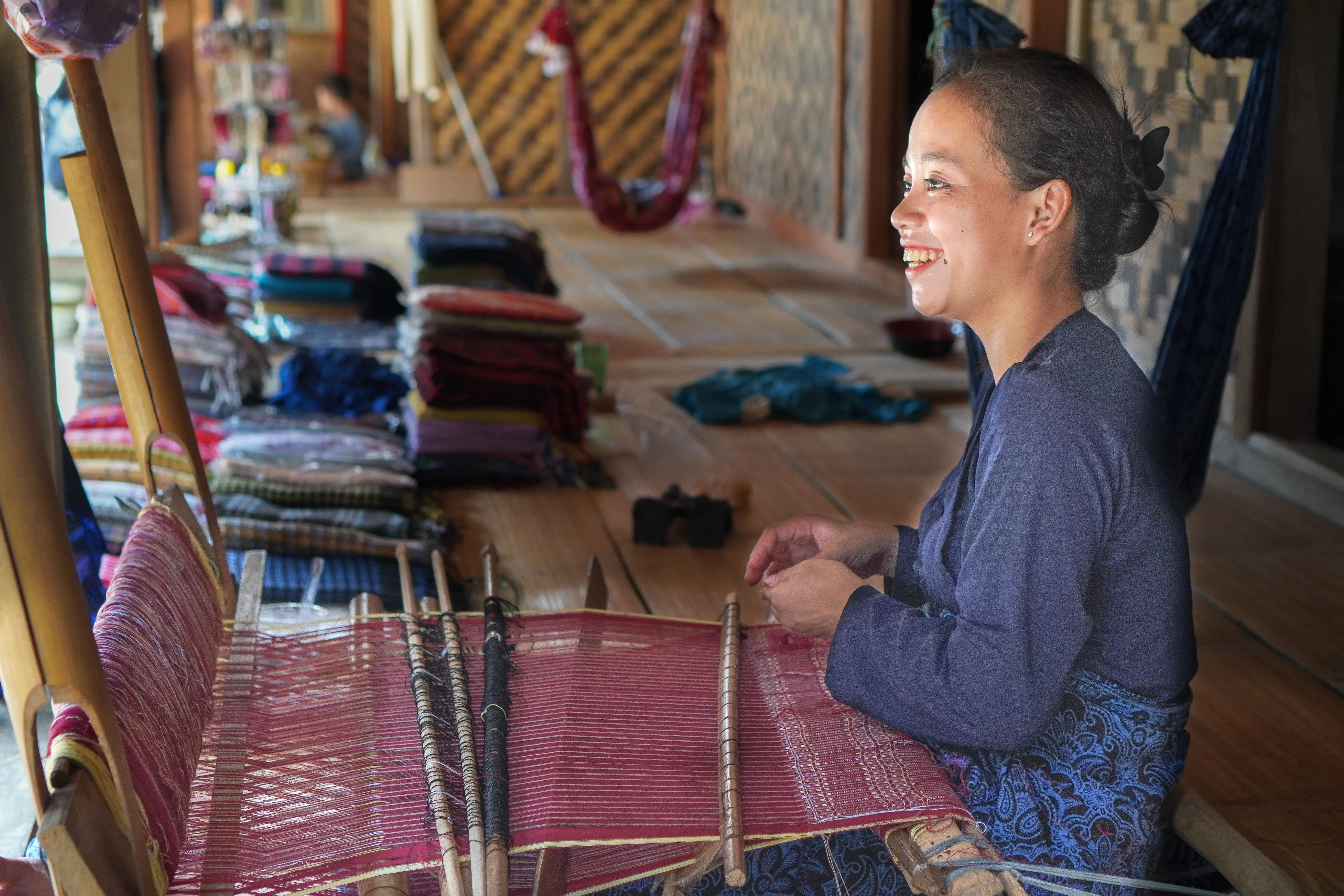 A woman is weaving traditional textile